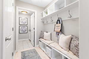 Mudroom with light tile patterned flooring