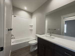 Full bathroom featuring shower / tub combination, vanity, toilet, and wood-type flooring