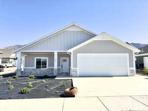 View of front of home featuring a mountain view and a garage