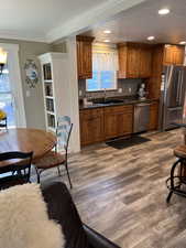 Kitchen featuring backsplash, appliances with stainless steel finishes, dark hardwood / wood-style floors, and sink