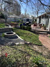 View of yard featuring a patio and a fire pit