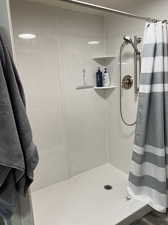 Bathroom featuring a shower with shower curtain