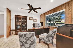 Tiled office with wooden walls and ceiling fan