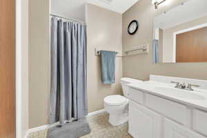 Bathroom with walk in shower, vanity, and toilet