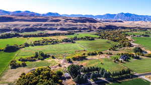 Birds eye view of property with a mountain view and a rural view