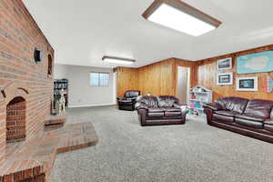 Living room featuring wood walls and carpet