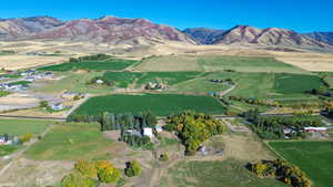 Drone / aerial view with a water and mountain view and a rural view