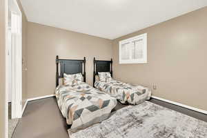 Bedroom featuring concrete floors and a textured ceiling