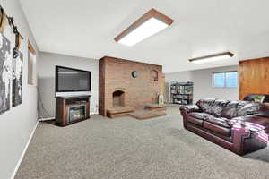 Living room featuring carpet and a fireplace