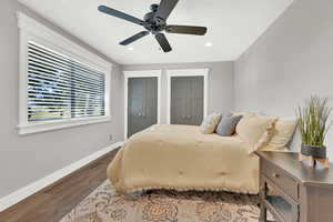 Bedroom with ceiling fan and hardwood / wood-style floors