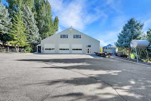 Back of house featuring an outbuilding and a garage