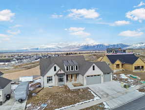 View of front facade featuring a garage and a mountain view