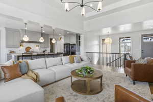 Living room with a notable chandelier and light hardwood / wood-style floors