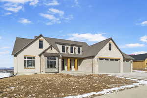 View of front facade with a porch and a garage