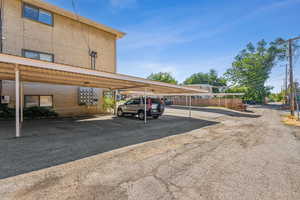 View of parking with a carport