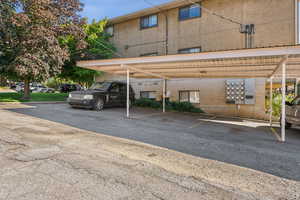 View of parking / parking lot with a carport