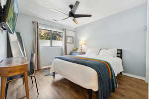 Bedroom with wood-type flooring and ceiling fan