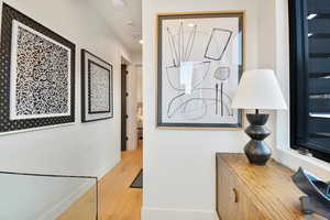 Hallway with light hardwood / wood-style floors