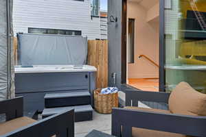 View of patio with a hot tub