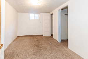 Interior space featuring a textured ceiling and carpet