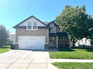 Craftsman inspired home featuring a 2 car garage and a beautiful yard