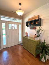 Beautiful entrance foyer with shiplap wall and hardwood floors