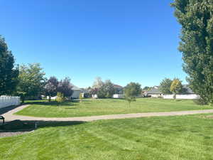 Views of the city park with mature trees and a walking path that winds all the way around the park