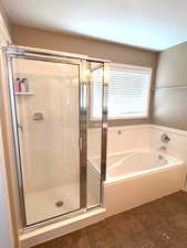 Separate garden tub and cultured marble shower in the master bathroom