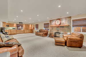 Family room with a tiled fireplace and light colored carpet