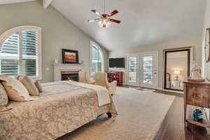 Master Bedroom with multiple windows, ceiling fan, dark hardwood / wood-style floors, and access to exterior