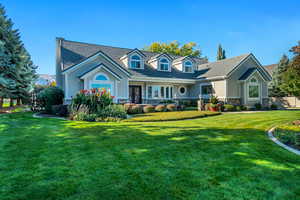 Cape cod-style house with a front yard