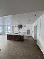 Kitchen with a textured ceiling and a large island