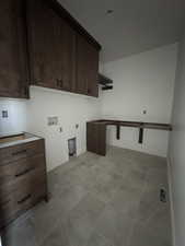 Washroom featuring washer hookup, electric dryer hookup, and cabinets