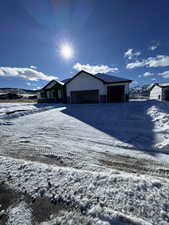 View of front of home with a garage and a mountain view