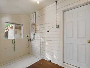 Interior space with electric panel and dark wood-type flooring