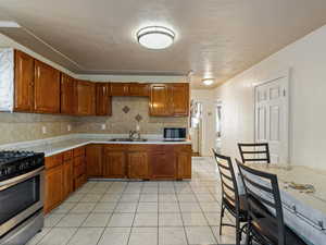 Kitchen with appliances with stainless steel finishes, tasteful backsplash, and sink