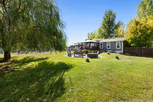 View of yard with a fire pit, a jacuzzi, and a patio