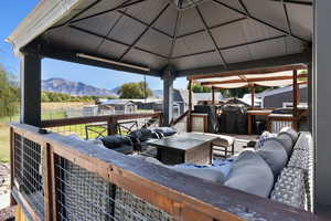 Exterior space featuring a storage shed, a mountain view, a gazebo, and an outdoor living space with a fire pit