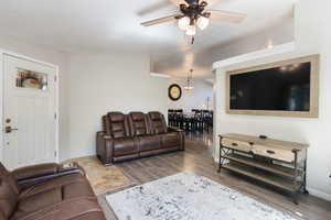 Living room featuring ceiling fan and hardwood / wood-style flooring