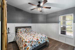 Bedroom featuring ceiling fan and dark hardwood / wood-style floors