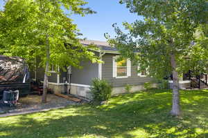 View of side of property with a lawn