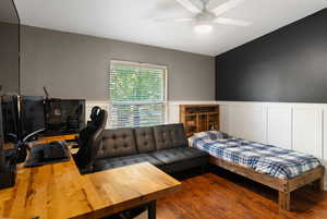 Bedroom featuring wood-type flooring and ceiling fan