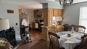 Dining space with a notable chandelier and dark hardwood / wood-style flooring