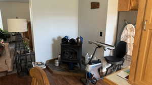 Interior space with dark wood-type flooring and a wood stove