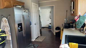 Kitchen featuring appliances with stainless steel finishes and dark hardwood / wood-style floors