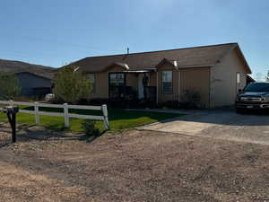 Ranch-style home featuring a front yard