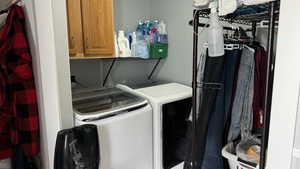 Laundry area with washer and dryer and cabinets