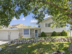 Split level home with a mountain view and a garage