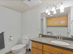 Bathroom featuring vanity, toilet, and tile patterned floors