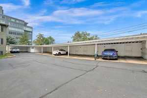 View of parking featuring a carport